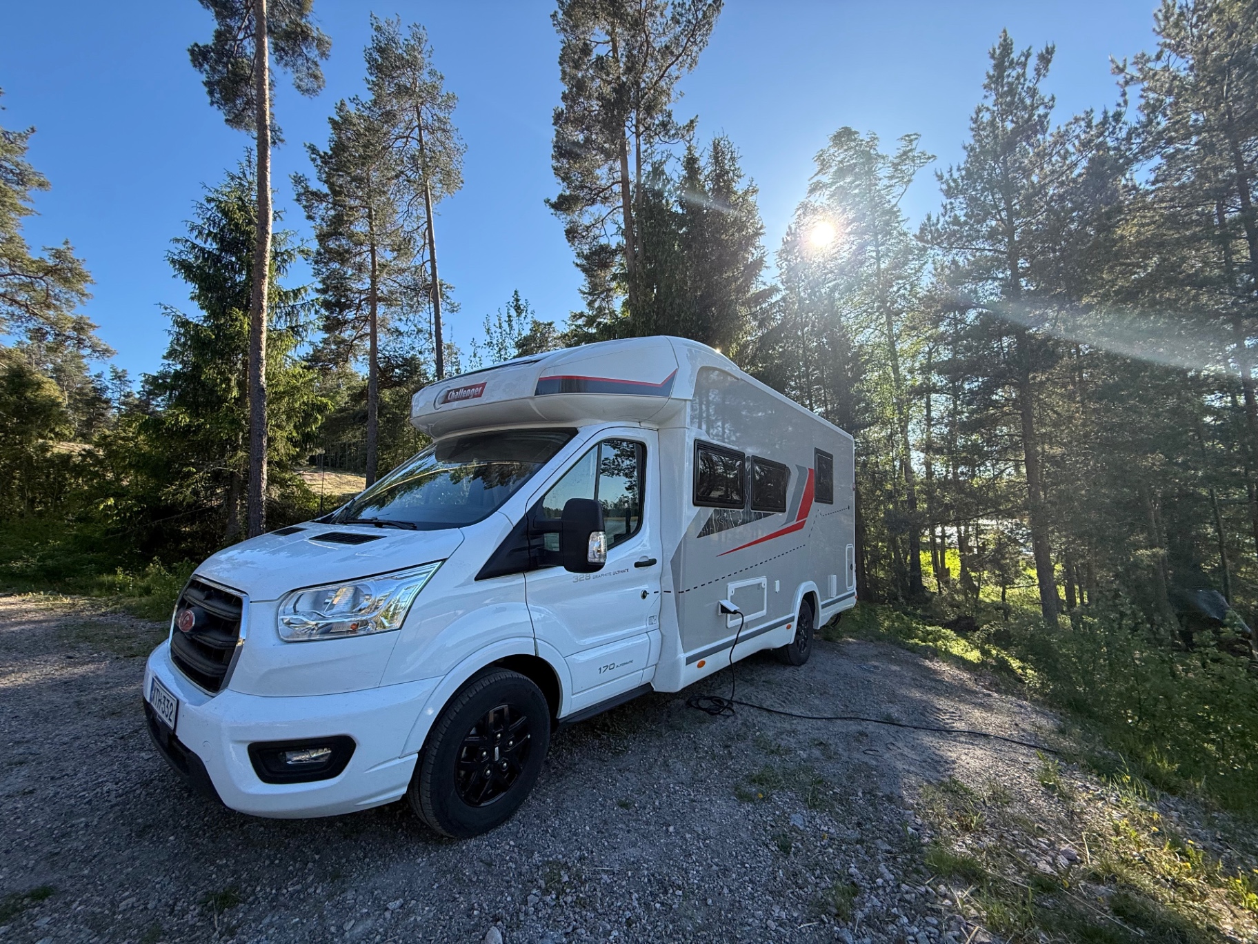 Archivan Challenger motorhome parked among pine trees in the Finnish archipelago
