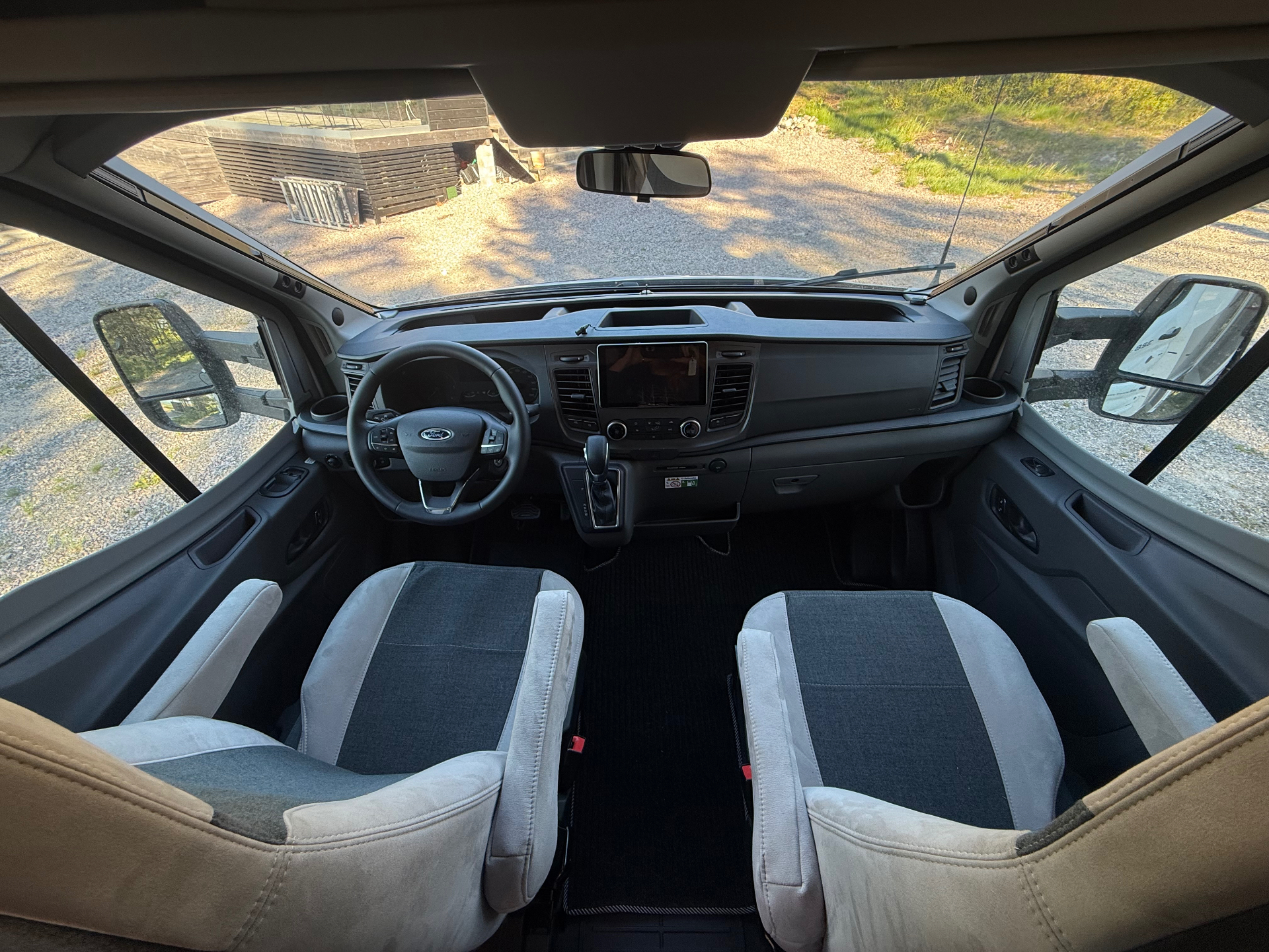 Driver and passenger cockpit with Ford steering wheel